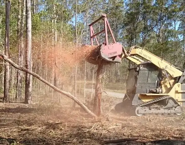 Forestry mulcher clearing vegetation